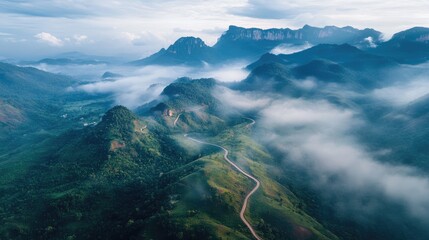 Aerial perspective of Thailand's Phu Thap Boek, featuring winding mountain roads and mist-covered peaks.