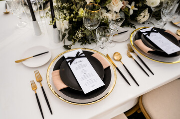 Wedding reception table with black and white place setting