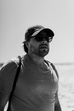 Portrait of bearded man, wearing sunglasses and baseball cap