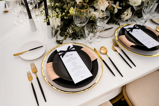 Wedding reception table with black and white place setting