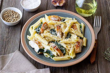 Pasta alfredo with chicken, spinach and cheese. Italian food.