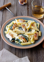 Pasta alfredo with chicken, spinach and cheese. Italian food.