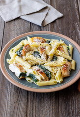Pasta alfredo with chicken, spinach and cheese. Italian food.