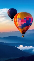 Colorful hot air balloons soaring over mountains at sunrise
