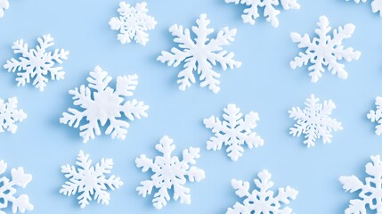 A collection of white snowflakes arranged on a light blue background, perfect for winter-themed designs and decorations. 