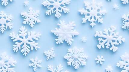 A clean and attractive background featuring an assortment of white snowflakes on a light blue surface, perfect for winter-themed designs. 