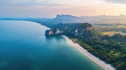 Obraz premium Aerial perspective of the serene Pak Meng Beach in Trang, with its curved shoreline and limestone cliffs in the distance.