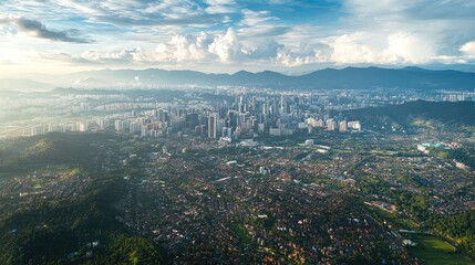 Fototapeta premium Aerial perspective of the urban sprawl of Kuala Lumpur, framed by the distant Titiwangsa mountain range.