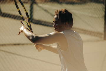 African-American man executing intense tennis forehand on hardcourt