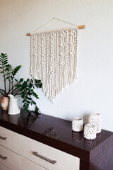 Macrame wall hanging handmade 100% cotton. ECO friendly modern knitting DIY natural decoration concept in the interior. Female hobby..