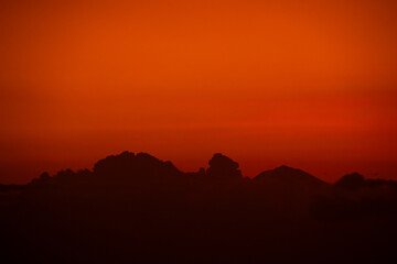orange sky at dusk with cloud silhouettes