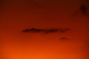 orange sky at dusk with cloud silhouettes