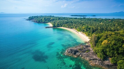 Top view of Koh Thmei, with its turquoise waters, sandy beaches, and dense forests teeming with wildlife.