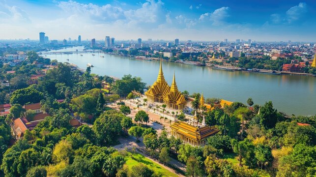 Top view of Phnom Penh's Royal Palace complex, with golden spires glistening under the bright blue sky and riverbank views.