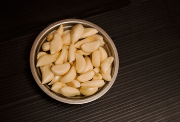 Garlic plate on black background