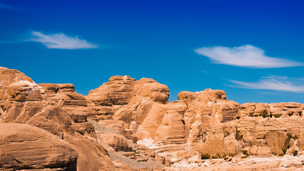 Fototapeta premium peaks of high stone rocks against a blue sky in Egypt Dahab South Sinai