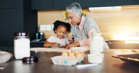 Grandmother, little girl and baking with cookie cutter on table in kitchen for learning, teaching or making dough at home. Grandma, child or junior baker with shapes for dessert or recipe at house