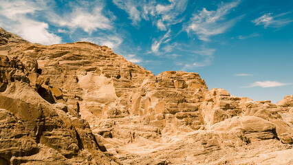 Fototapeta premium high rocky mountains in the desert against the blue sky and white clouds in Egypt Dahab South Sinai