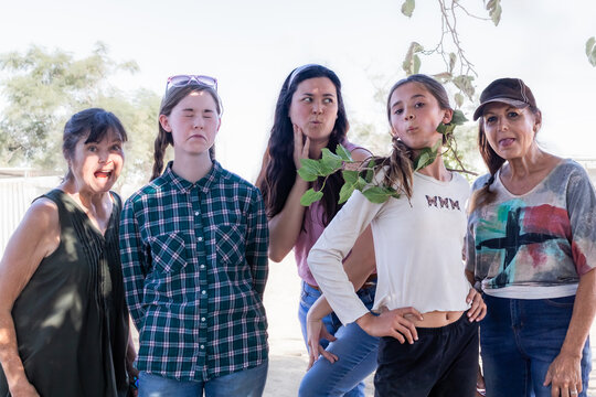 Five Family Members Posing in a Line, With Silly Faces, Outside on Sunny Day, California, USA, horizontal