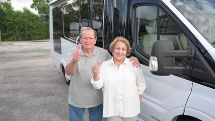 happy customers chose a camper van for purchase at the RV dealership, giving a happy smile and thumbs-up sign