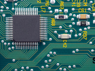 Close-up of microcircuits and components: chips, diodes and capacitors on a printed circuit board,...