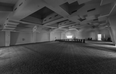 empty dark religious hall with black chairs