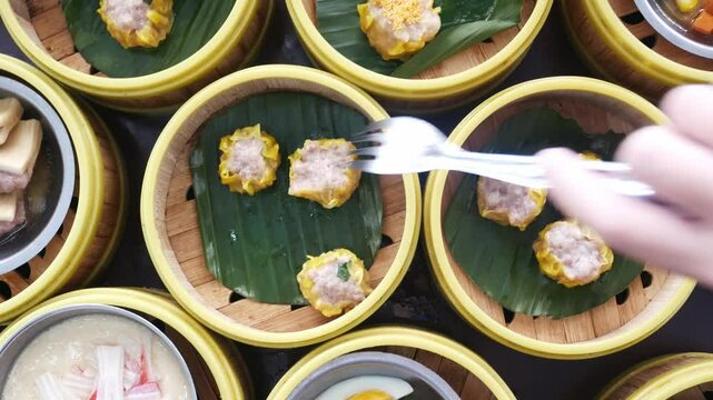 top down view to table full with streamers with dumpling dimsum for morning breakfast chinese meal,shu mai Chinese hong kong style breakfast food steamed dumplings stuffed meat