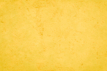 Yellow concrete stone texture for background in summer wallpaper. Cement and sand wall of tone vintage minimal. Concrete abstract wall of light orange color, cement texture white blank for home decor.