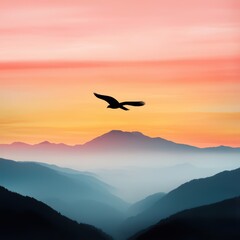 Naklejka premium A silhouette of a bird soaring over misty mountains at sunrise, creating a serene and tranquil atmosphere.