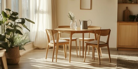 Fototapeta premium A wooden dining table with four chairs around it and a vase of flowers on it. The room is bright and airy, with a large window letting in plenty of natural light