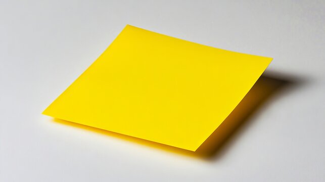 A yellow post-it note on a white surface