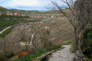 Landscape with a panoramic view of mountains and greenery against a blue sky with clouds in the city of Cuenca, near Madrid, Spain