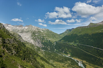 Naklejka premium Road tripping through the Swiss Alps on Grimselpass, with its panoramic views
