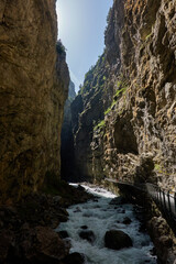 Hiking to the Gletscherschlucht glacier in Grindelwald, with imposing canyons, waterfalls and panoramic views of the valley. Swiss Alps