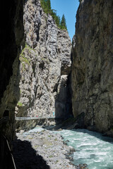 Hiking to the Gletscherschlucht glacier in Grindelwald, with imposing canyons, waterfalls and panoramic views of the valley. Swiss Alps