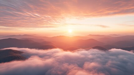 Fototapeta premium A breathtaking sunrise over misty mountains, showcasing nature's beauty and tranquility.