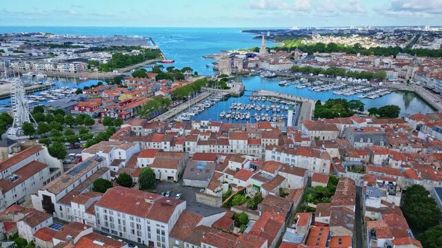 Seen on the famous city of La Rochelle with in the background the famous chain and St Nicolas towers. Aerial drone descending forward