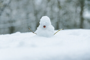 single small snow man close up outdoor winter December view snowy white environment space with...