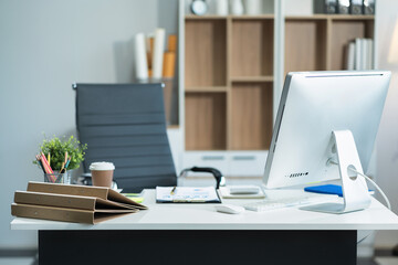 Workspace with desktop computer, office supplies, houseplant and coffee cup at office. desk work concept.