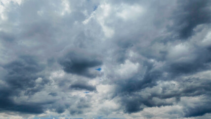 Dramatic storm clouds fill the sky, symbolizing unpredictable weather conditions and natural phenomena