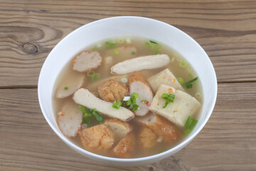 Close-up of Korean Food fish cake soup on bowl with wood floor with the background of South Korea 