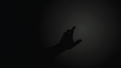 Silhouette of a hand reaching out in the darkness.