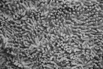 Processed image of fluffy gray doormat from bathroom in grey color