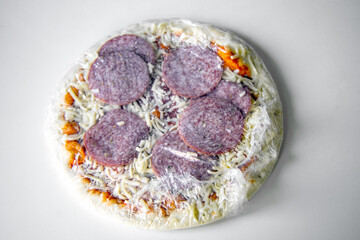 Frozen semi-finished pizza from the supermarket. Fast food concent