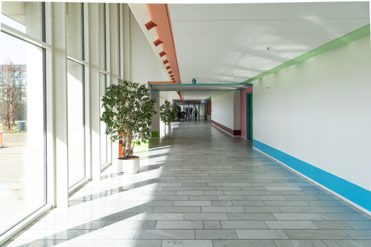 Long bright hall corridor with large windows and green plants in Herlev hospital.
