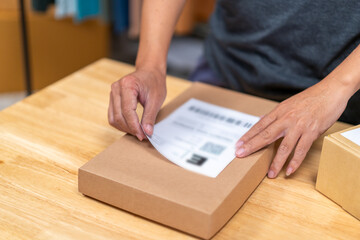 Young Asian man, distributor, online shop owner, small business owner, standing in warehouse and...