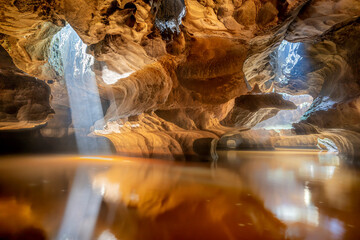 View of mystical flooded cave with beautiful limestone formations and serene reflections, Hang Son Tra, Vietnam.