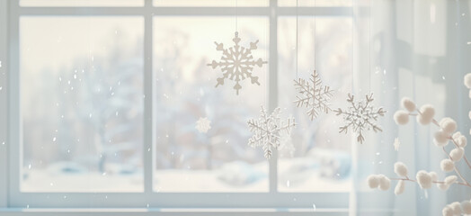Delicate snowflake decorations hang by a window, capturing the essence of winter and holiday season