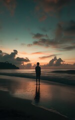 Fototapeta premium Person standing on a beach at dawn, ready to begin a new day