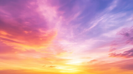 Vivid sunset sky with vibrant orange, pink, and purple hues blending together as the sun dips below the horizon.